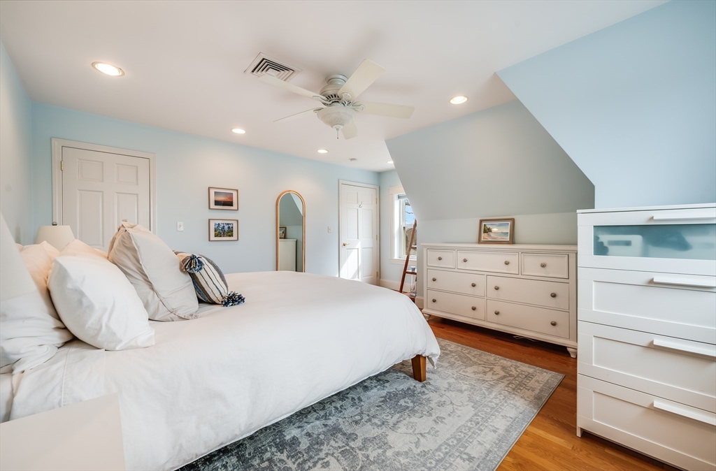 39 Chestnut Street, Unit 2C Stoneham, MA 02180 - Photo 11 of 21 a bedroom with a bed and a dresser