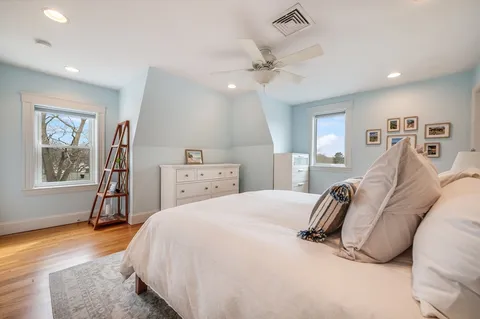 a spacious bedroom with a bed and a chandelier