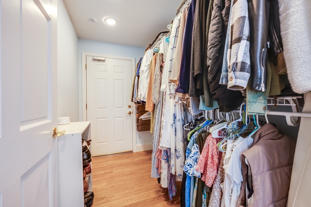 39 Chestnut Street, Unit 2C Stoneham, MA 02180 - Photo 13 of 21 a view of walk in closet with clothes and shoes