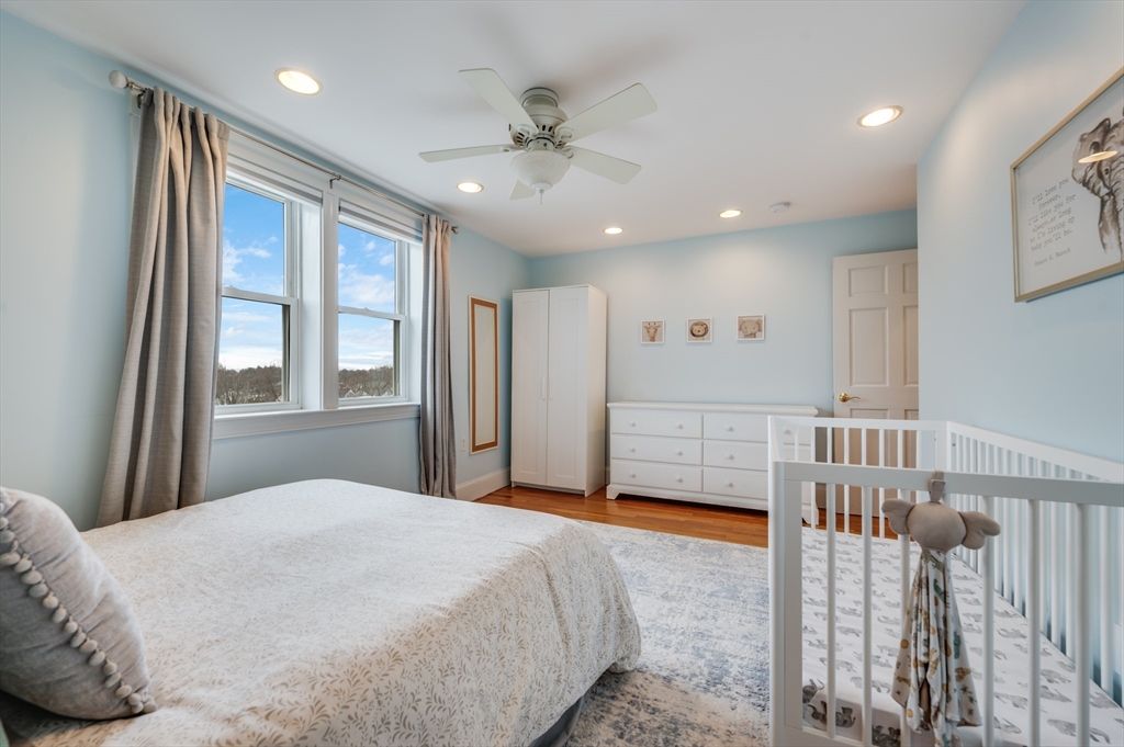 39 Chestnut Street, Unit 2C Stoneham, MA 02180 - Photo 17 of 21 a bedroom with furniture and a window