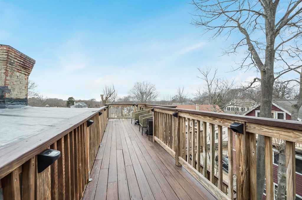 39 Chestnut Street, Unit 2C Stoneham, MA 02180 - Photo 18 of 21 a view of roof deck with wooden fence and floor