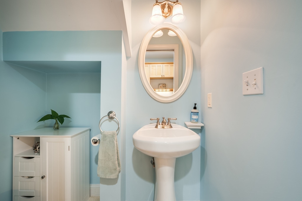39 Chestnut Street, Unit 2C Stoneham, MA 02180 - Photo 8 of 21 a bathroom with a sink and a mirror