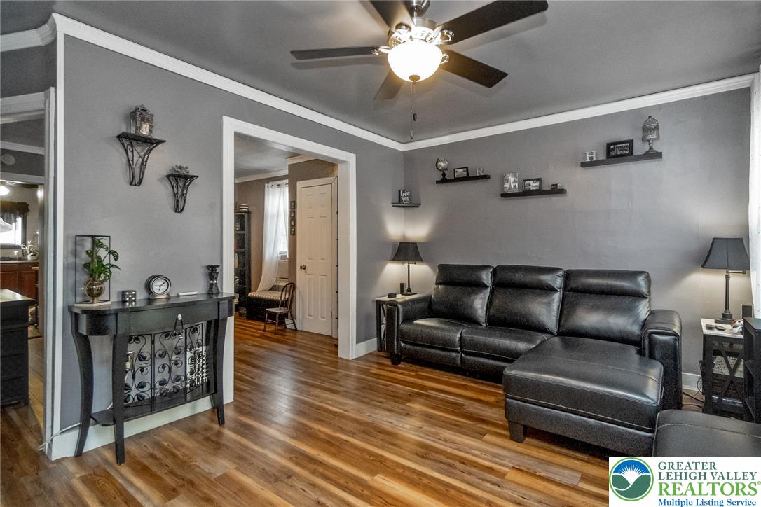 365 Rock Street Easton, PA 18042 - Photo 7 of 50 Wood flooring and ceiling fan enhance the livability of this well-lit living area.