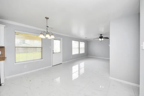 a view of a room with windows and chandelier