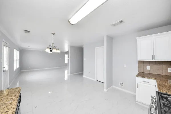 a view of a kitchen with a sink and cabinets