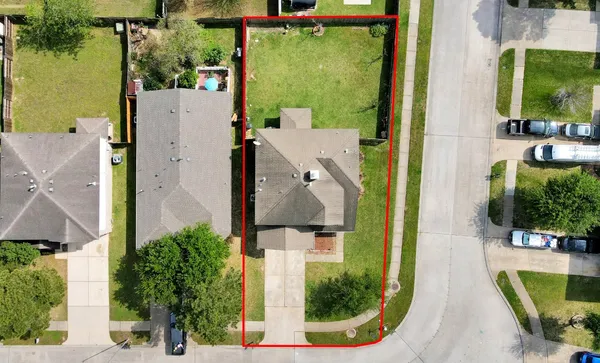 an aerial view of a house with swimming pool and outdoor seating