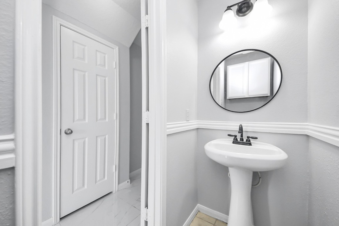 2406 Gwenfair Drive Spring, TX 77373 - Photo 21 of 44 a bathroom with a sink and a mirror