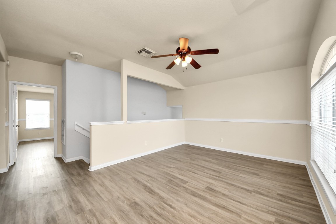 2406 Gwenfair Drive Spring, TX 77373 - Photo 23 of 44 a view of empty room with wooden floor and fan
