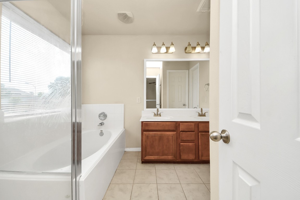 2406 Gwenfair Drive Spring, TX 77373 - Photo 32 of 44 a spacious bathroom with a tub sink and mirror