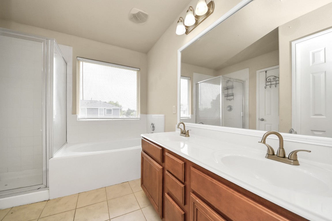 2406 Gwenfair Drive Spring, TX 77373 - Photo 33 of 44 a bathroom with a tub sink and mirror