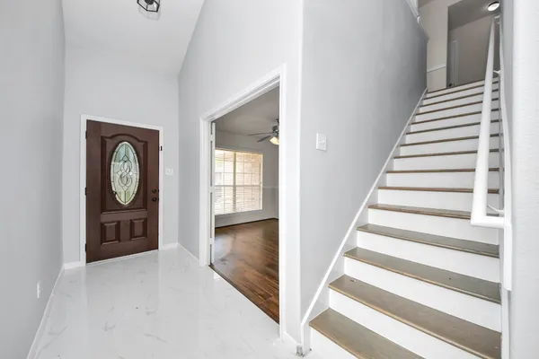 a view of an entryway with wooden floor