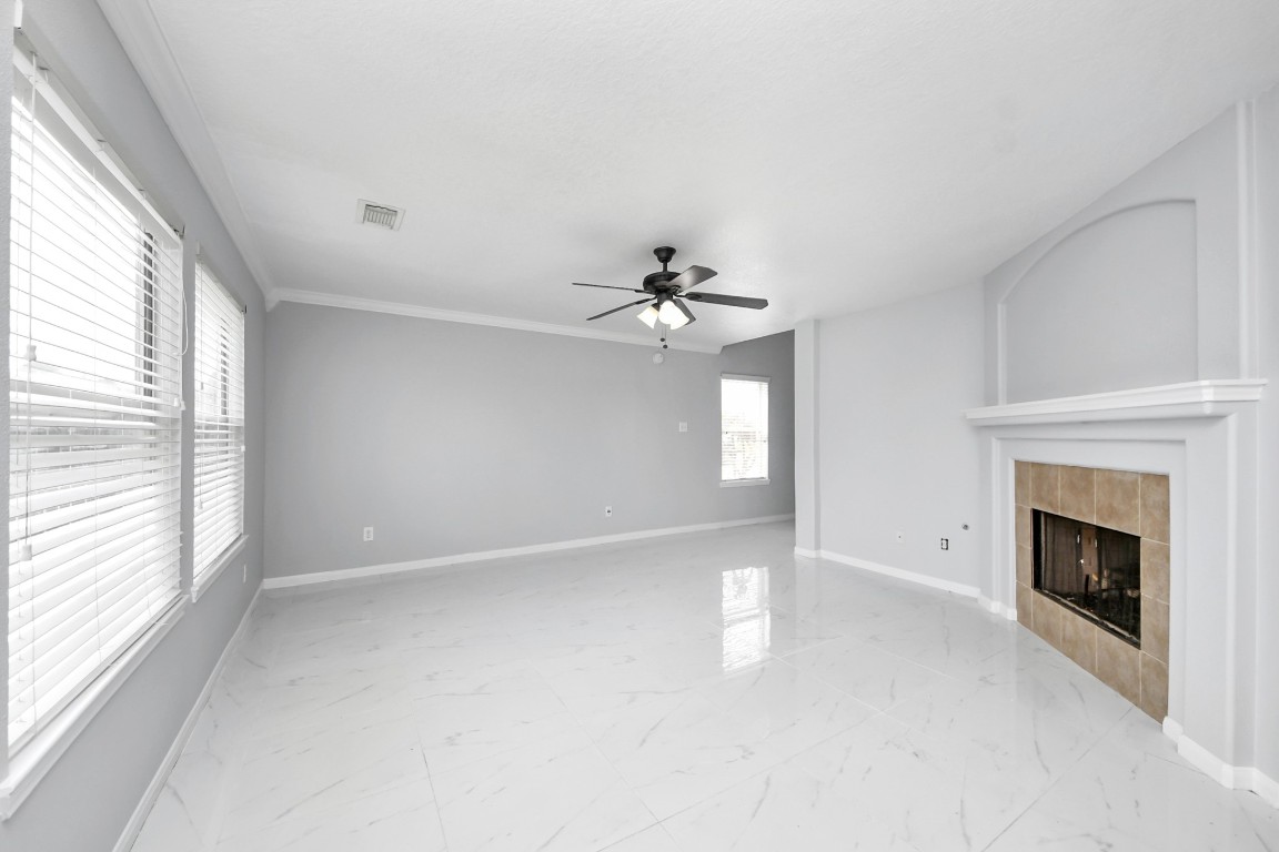 2406 Gwenfair Drive Spring, TX 77373 - Photo 9 of 44 a view of an empty room with chandelier fan and fire place