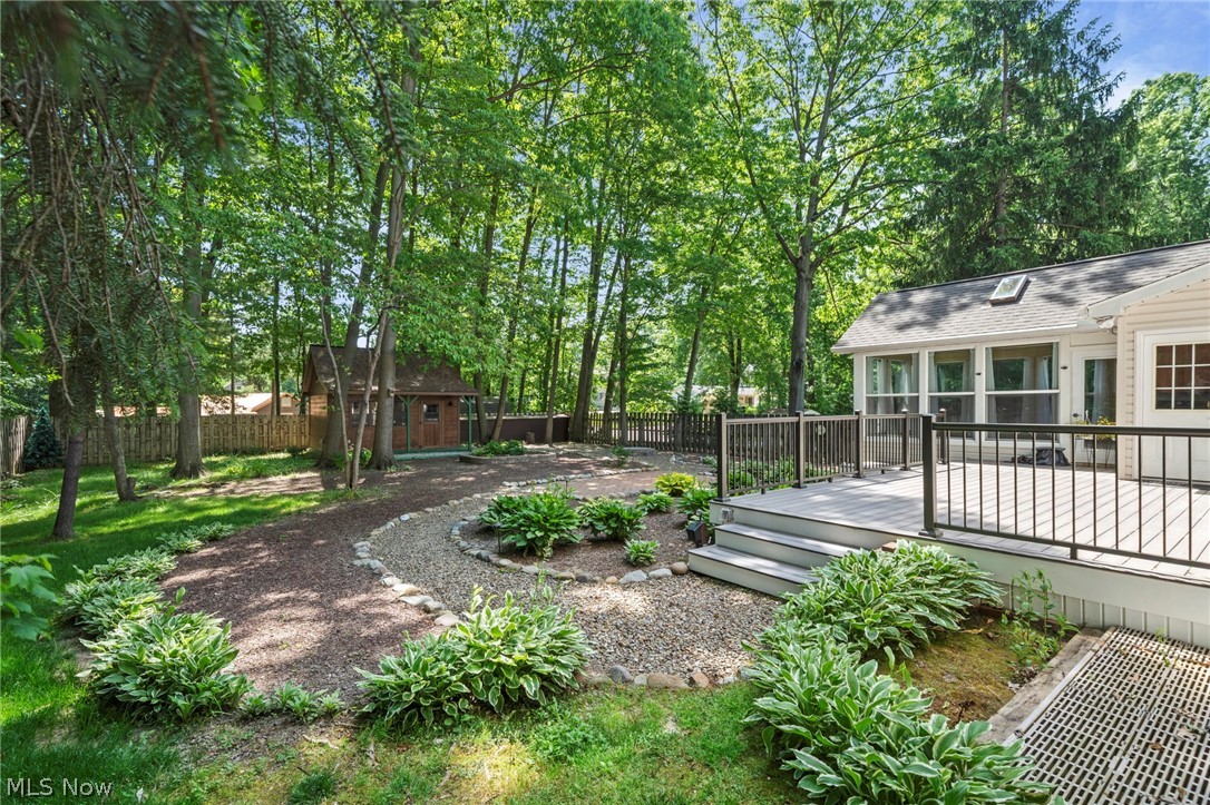 3871 Greentree Road Stow, OH 44224 - Photo 43 of 50 Spacious backyard featuring a multi-level composite deck with dark railings, a sunroom with large windows and a skylight, and mature trees providing natural shade