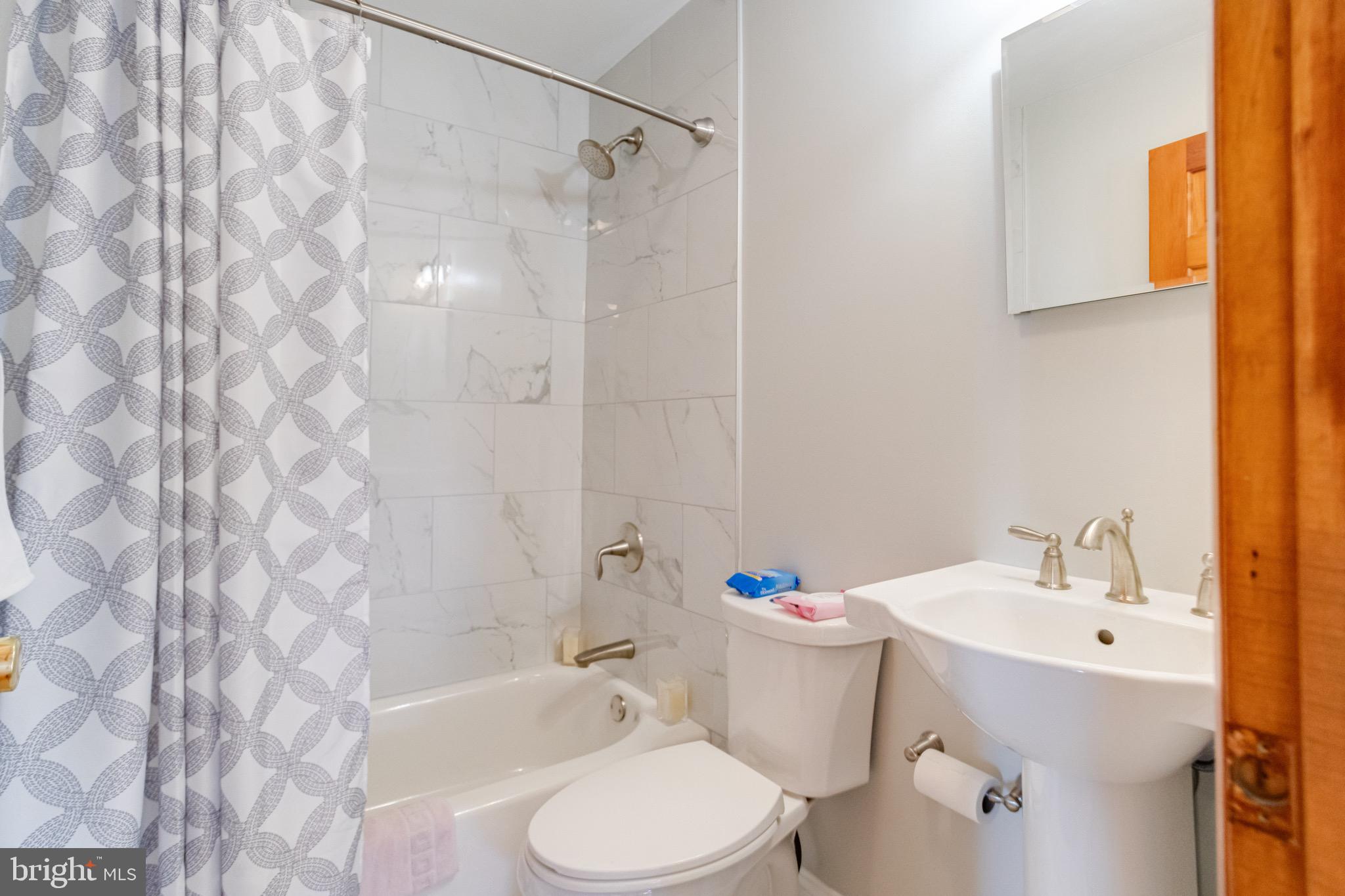 1452 Galena Road Baltimore, MD 21221 - Photo 42 of 80 a bathroom with a sink toilet and shower