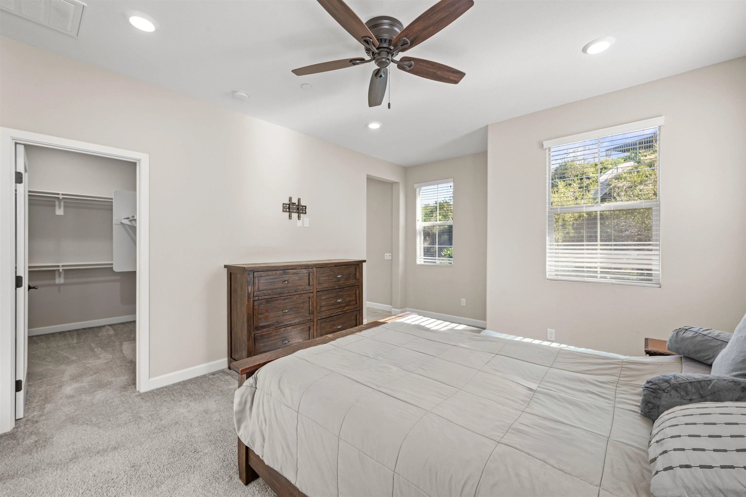 1151 Delpy View Point Vista, CA 92084 - Photo 22 of 44 a bedroom with a bed and a chandelier