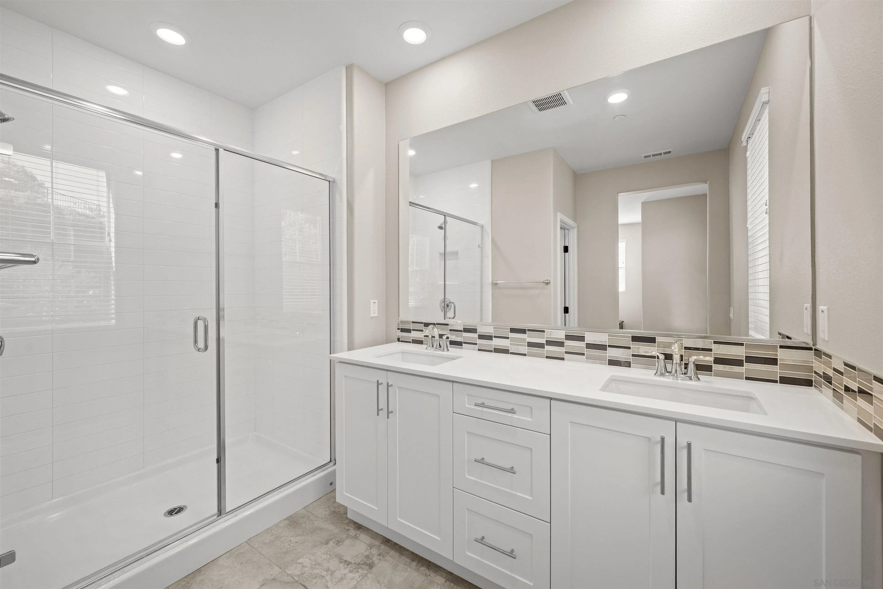 1151 Delpy View Point Vista, CA 92084 - Photo 24 of 44 a bathroom with double sink and a mirror