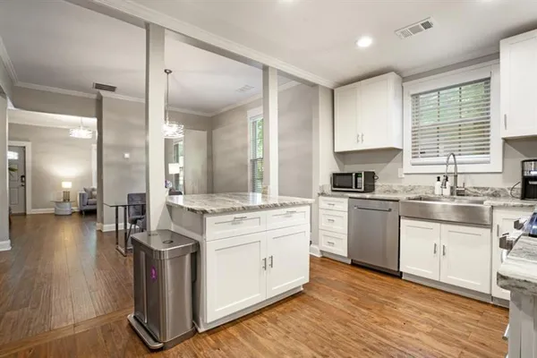 a kitchen with a stove a sink and a refrigerator