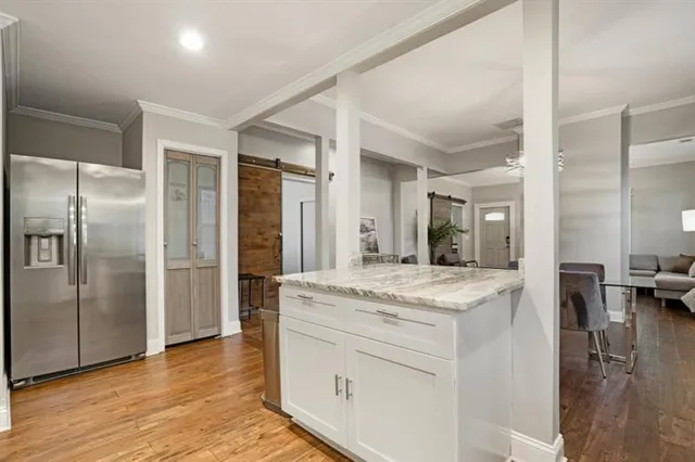 a kitchen with stainless steel appliances granite countertop a refrigerator and a sink