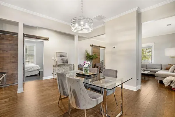 a view of a dining room with furniture and wooden floor