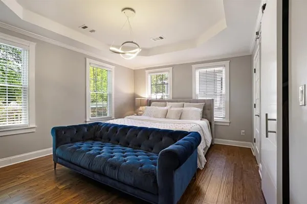 a spacious bedroom with a bed and windows