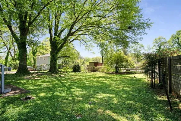 a yellow house with trees in front of it