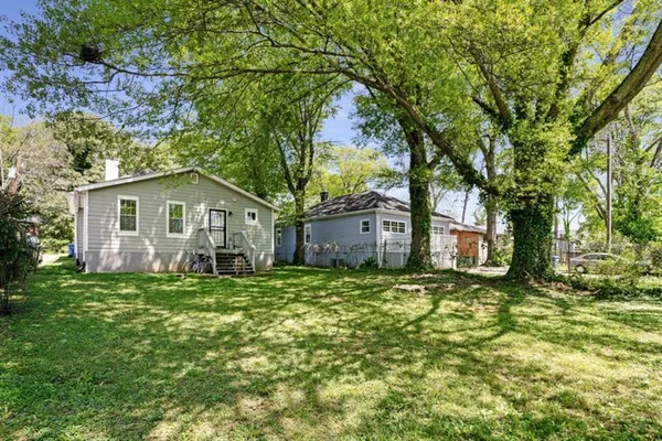 a house that has a tree in front of it