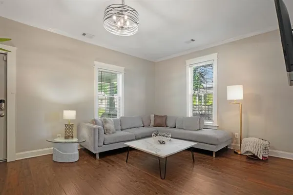 a living room with furniture wooden floor and window