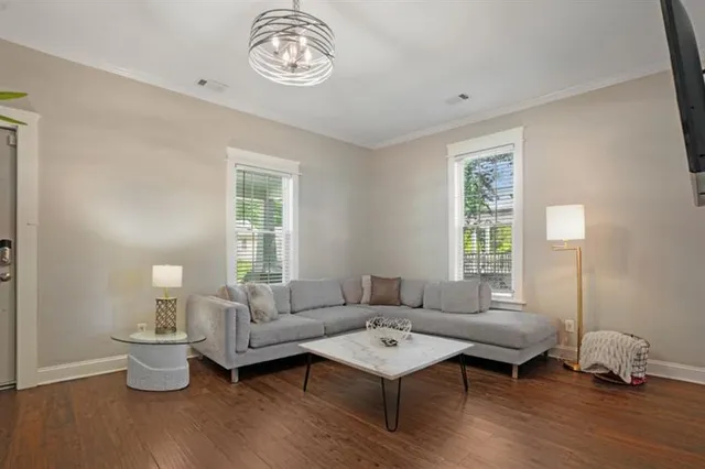 a living room with furniture wooden floor and window