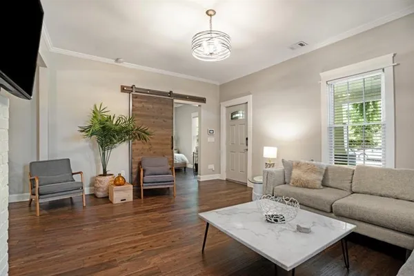 a living room with furniture potted plant and a window