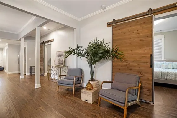 a living room with furniture and wooden floor