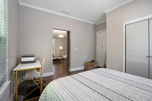 a bedroom with a bed and a desk in it