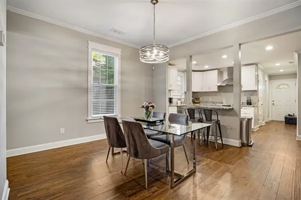 a view of a dining room with furniture window and wooden floor