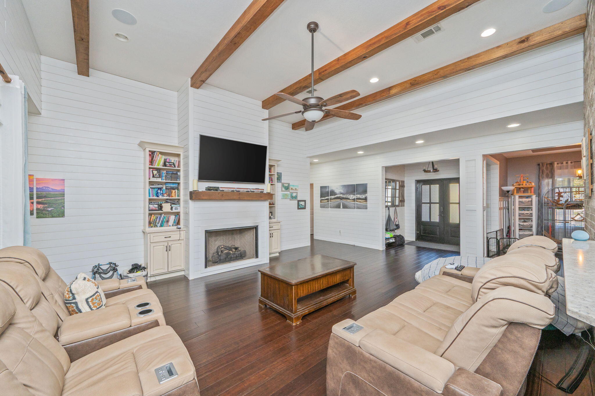 5777 Wildwood Road Crestview, FL 32536 - Photo 11 of 68 a living room with furniture a fireplace and a flat screen tv