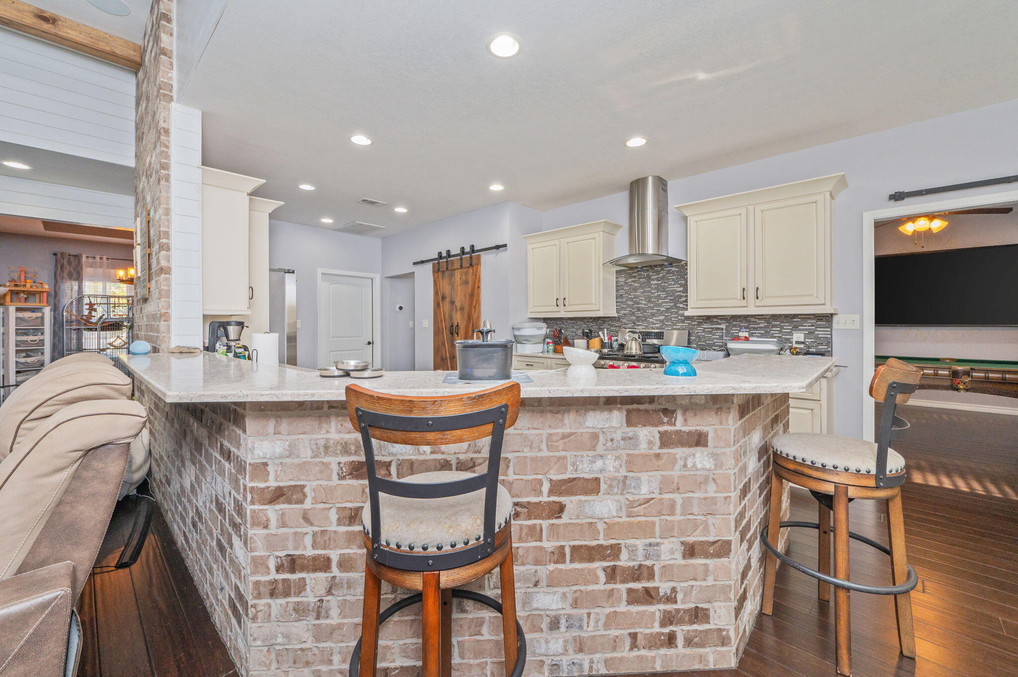 5777 Wildwood Road Crestview, FL 32536 - Photo 12 of 68 a kitchen with stainless steel appliances granite countertop a stove top oven a sink a counter space and cabinets