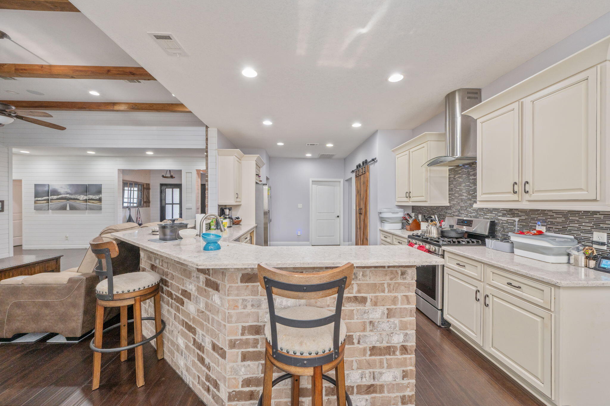 5777 Wildwood Road Crestview, FL 32536 - Photo 13 of 68 a kitchen with stainless steel appliances kitchen island granite countertop a sink and cabinets
