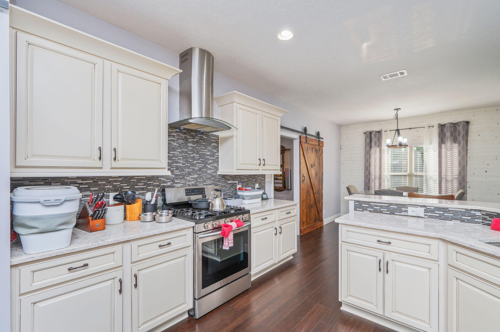5777 Wildwood Road Crestview, FL 32536 - Photo 16 of 68 a kitchen with stainless steel appliances granite countertop a sink dishwasher stove and cabinets with wooden floor