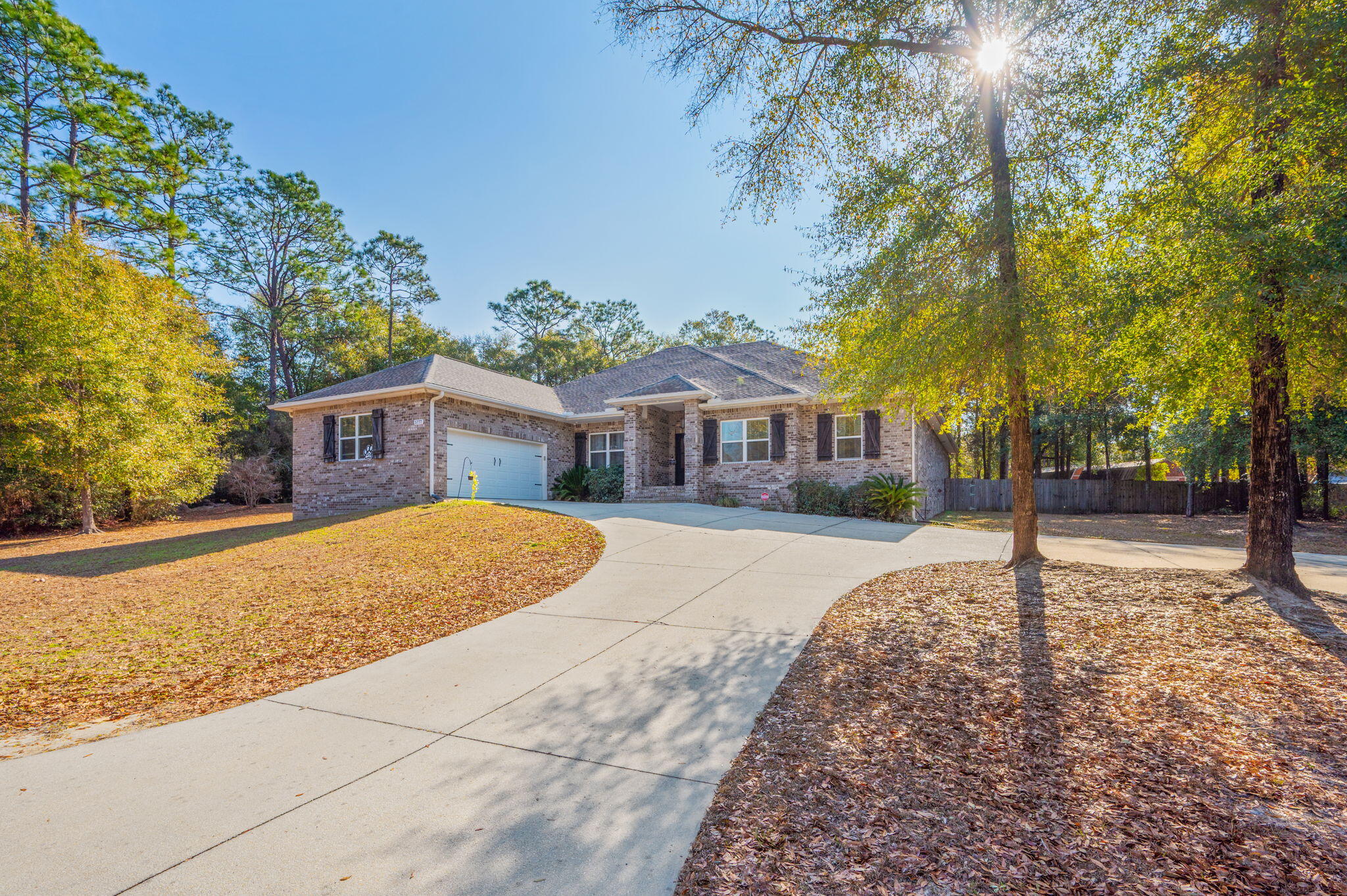 5777 Wildwood Road Crestview, FL 32536 - Photo 2 of 68 a house with trees in the background