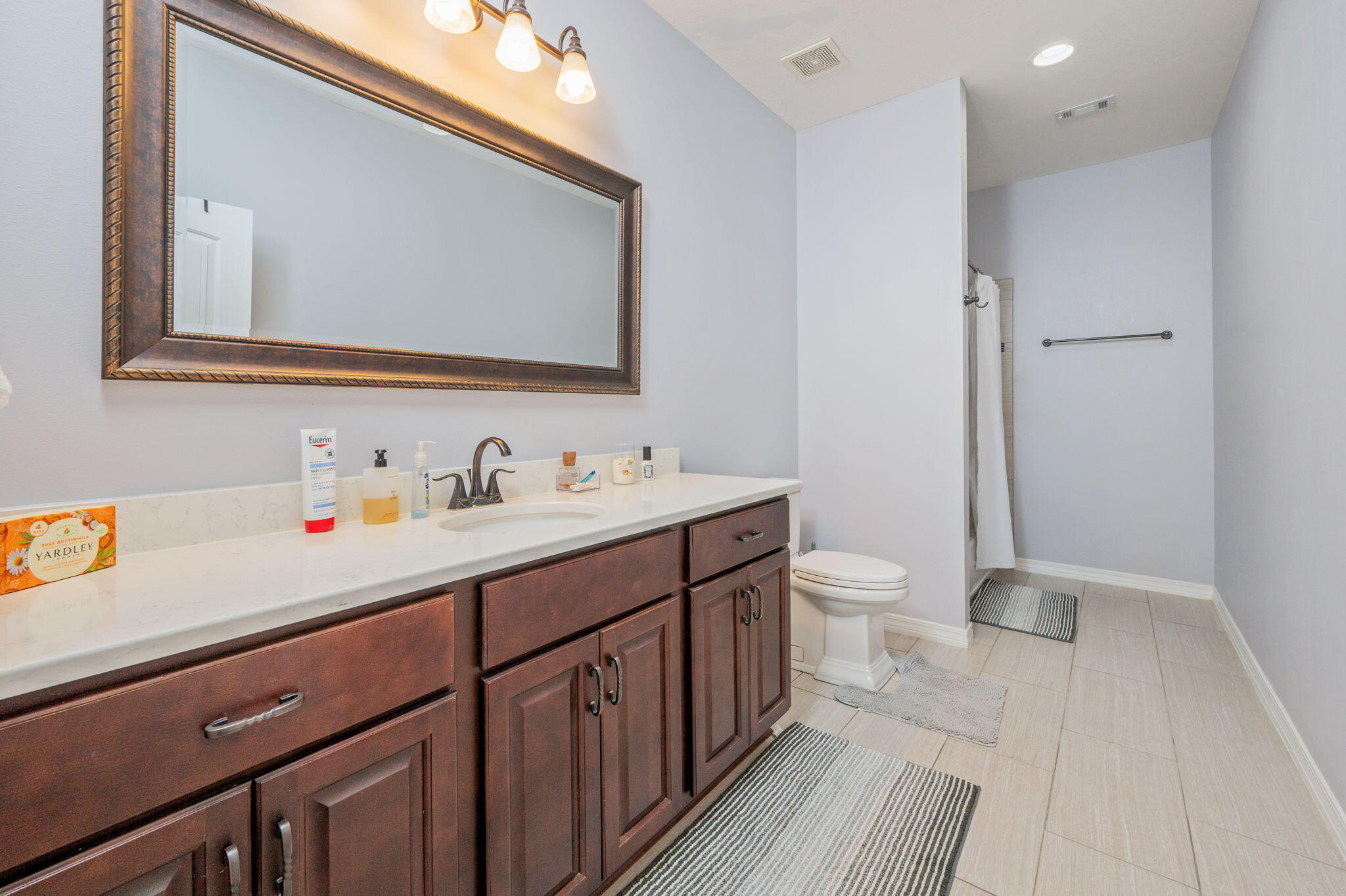 5777 Wildwood Road Crestview, FL 32536 - Photo 25 of 68 a bathroom with a double vanity sink mirror and toilet