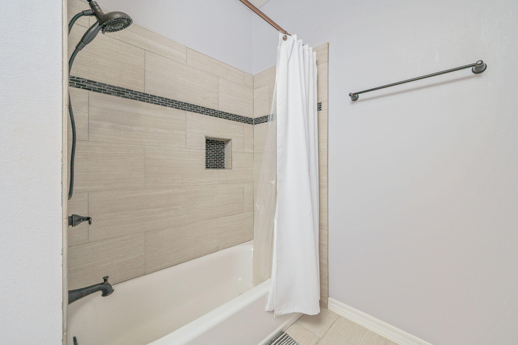 5777 Wildwood Road Crestview, FL 32536 - Photo 26 of 68 a bathroom with a bathtub and a shower