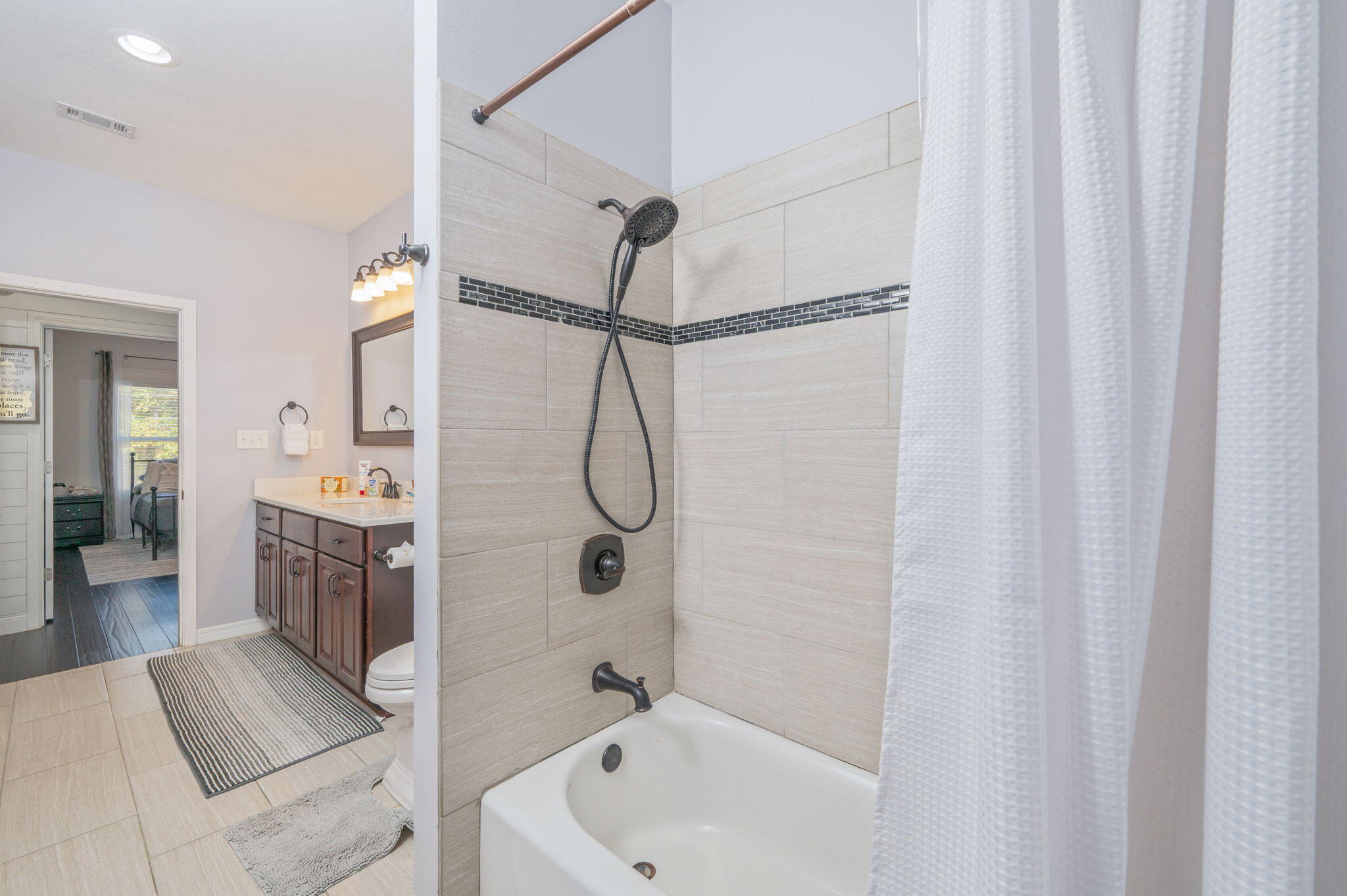 5777 Wildwood Road Crestview, FL 32536 - Photo 27 of 68 a bathroom with a shower curtain and a sink
