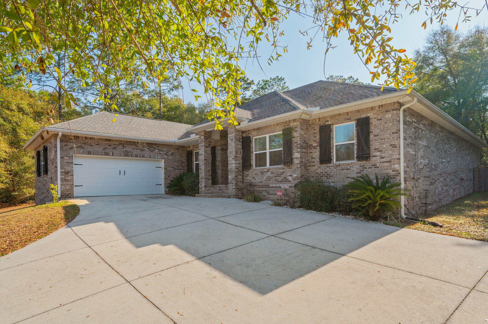5777 Wildwood Road Crestview, FL 32536 - Photo 3 of 68 a front view of a house with a garden