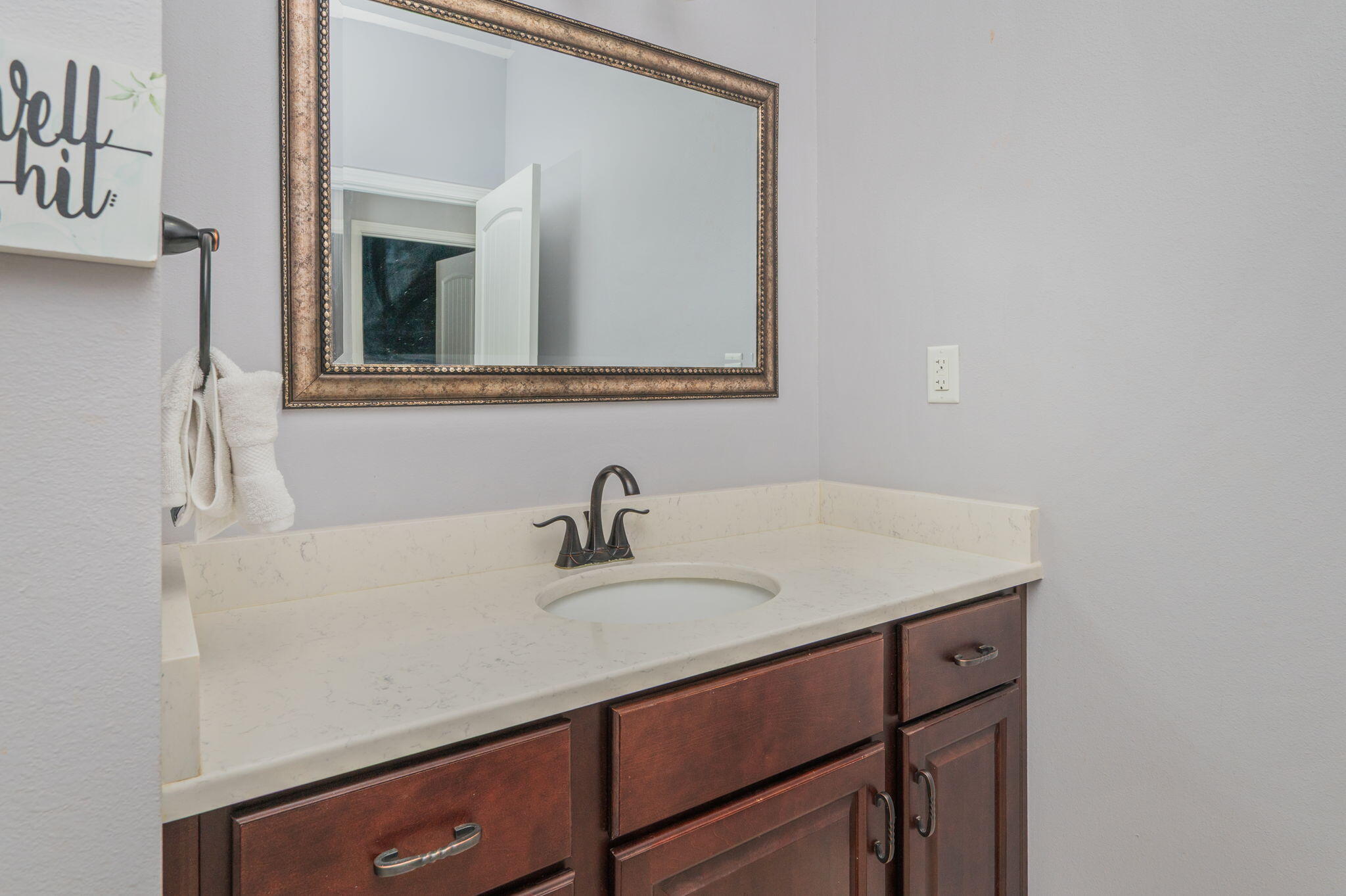 5777 Wildwood Road Crestview, FL 32536 - Photo 36 of 68 a bathroom with a sink vanity and mirror