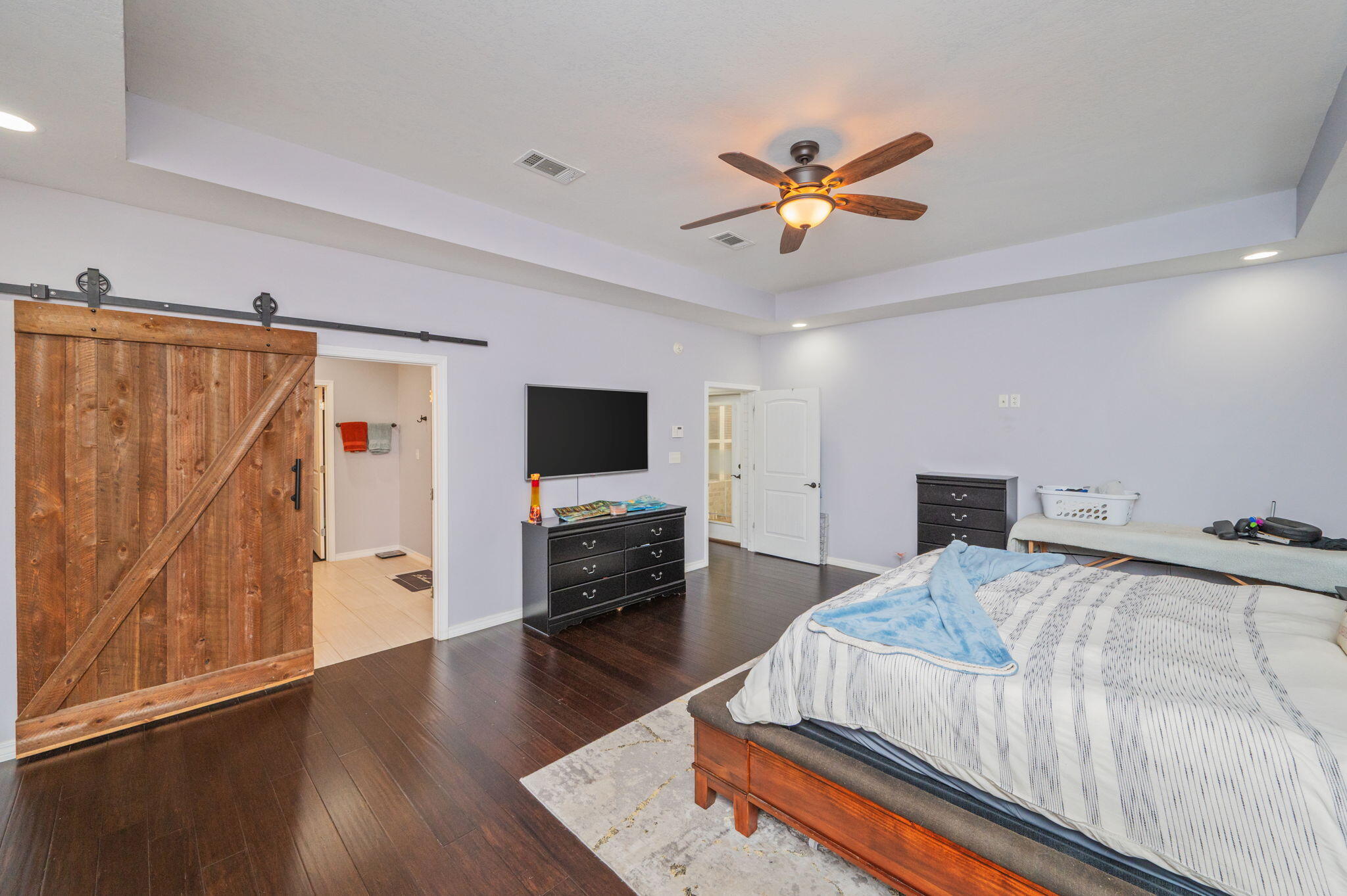 5777 Wildwood Road Crestview, FL 32536 - Photo 39 of 68 a bedroom with a bed and a flat screen tv