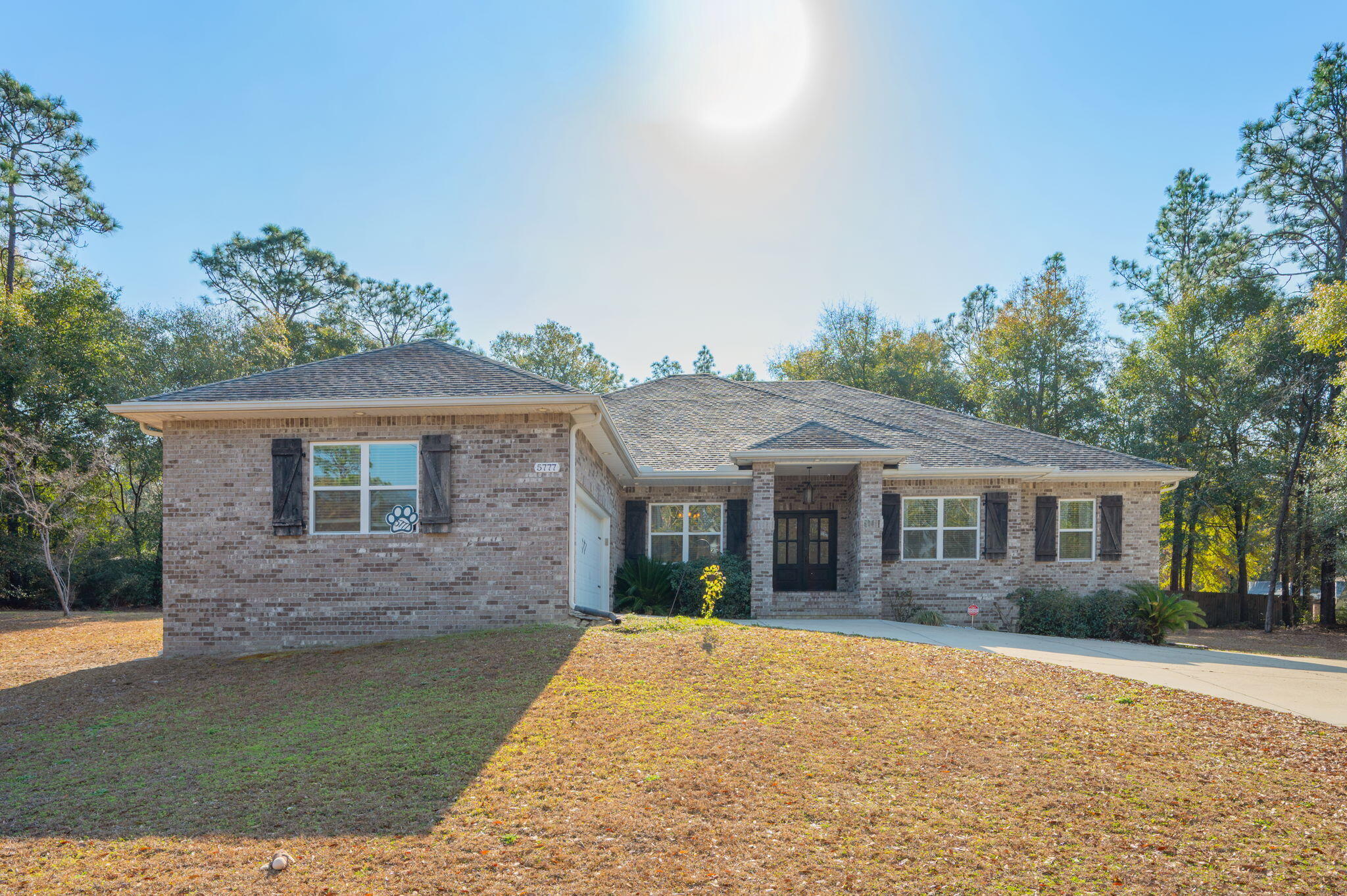 5777 Wildwood Road Crestview, FL 32536 - Photo 4 of 68 a front view of a house with a garden
