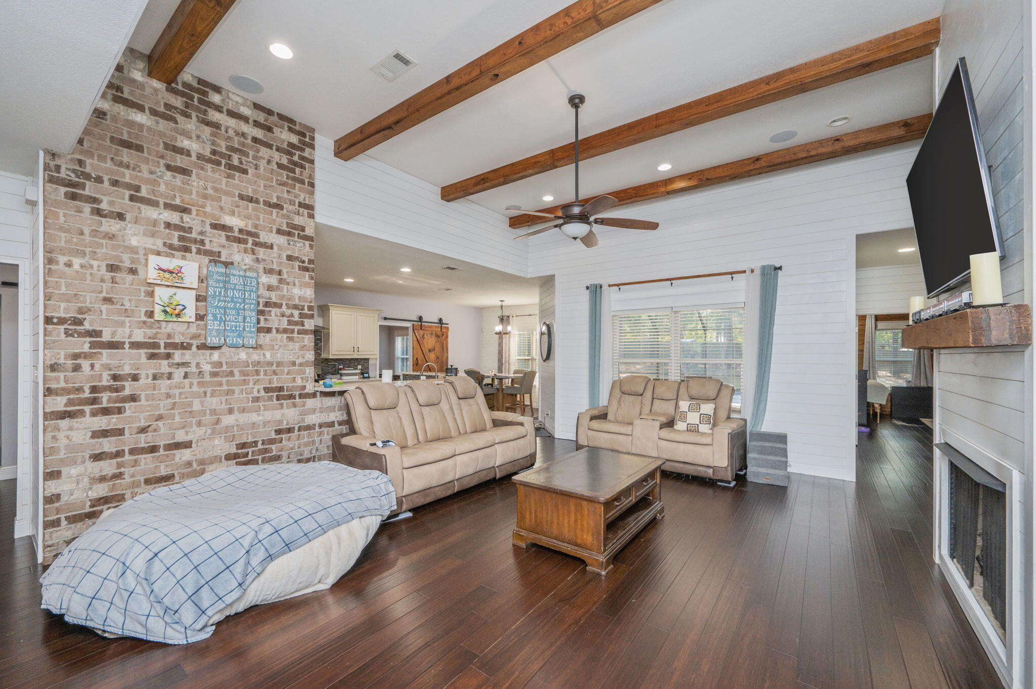 5777 Wildwood Road Crestview, FL 32536 - Photo 9 of 68 a living room with fireplace furniture and a flat screen tv