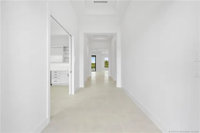 a bedroom with a large bed and a potted plant
