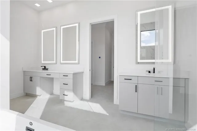 a bathroom with a double vanity sink a large mirror and shower