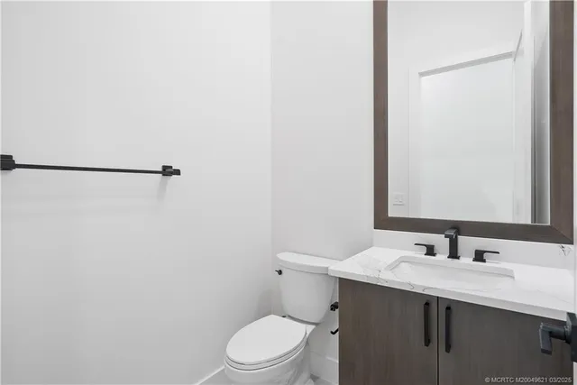 a kitchen with kitchen island granite countertop a sink stove and cabinets