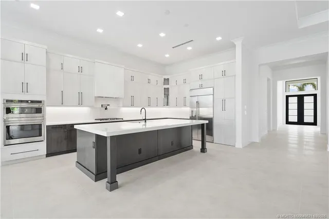 a kitchen with stainless steel appliances a refrigerator and cabinets