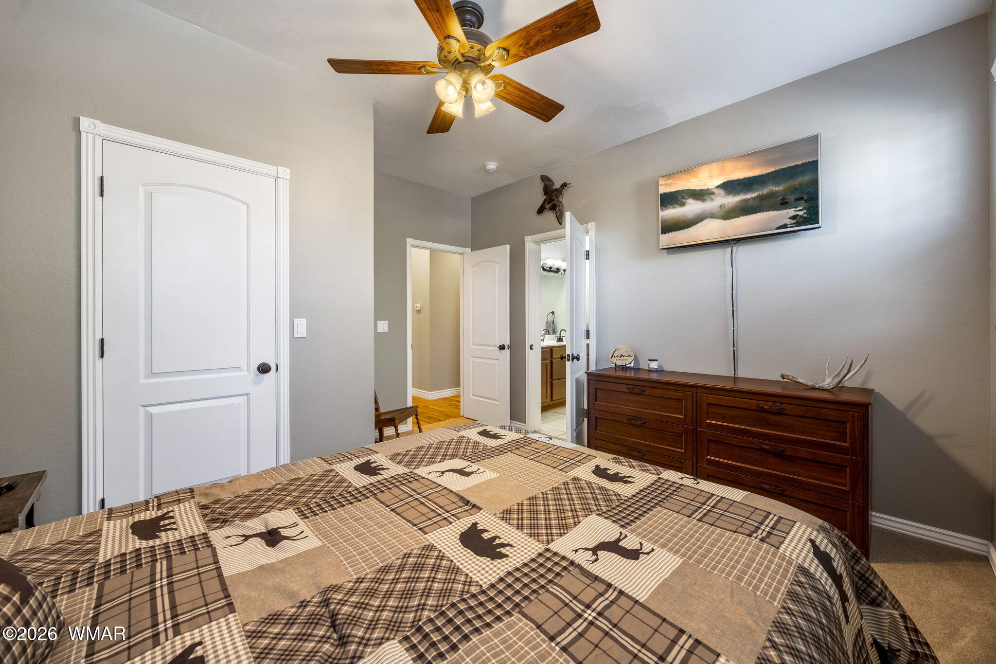 1940 Stonegate Way Heber, AZ 85928 - Photo 30 of 62 a bedroom with a bed and a chandelier